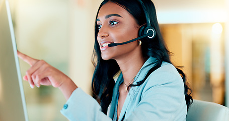 Image showing Professional and helpful call centre woman using a headset, assists business consult. Helpful support service agent talks with client on call. Remote worker gives client advice telephonically