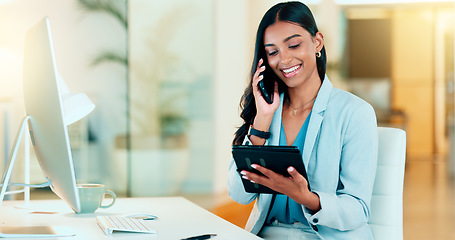 Image showing Happy manager talking on a phone in modern office, booking appointment or arranging a meeting on tablet. Young, carefree professional female talking to a client while responding to emails