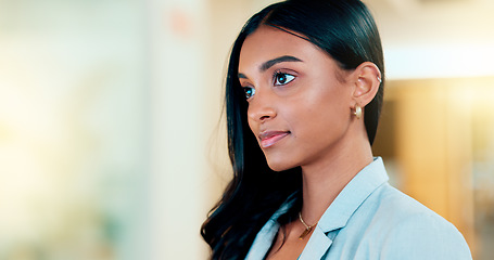 Image showing Business woman reading information on a computer screen while working in an office. Closeup on face of one confident young entrepreneur and focused expert carefully analyzing ideas and plans online