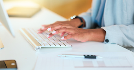 Image showing Closeup of a womans hands typing on a keyboard while sitting at a desk and sending an email in an office. Financial advisor doing online research for a budget plan and communicating with clients