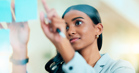 Image showing A smart female entrepreneur planning the strategy of her company in the office. Young confident and successful business woman leader thinking and working on a project at the workplace