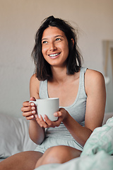 Image showing I cant wait to see what this day will bring. Shot of a young woman enjoying a relaxing cup of coffee in bed at home.