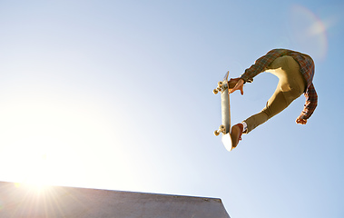 Image showing Have you see the skills on this one. A young man doing tricks on his skateboard at the skate park.