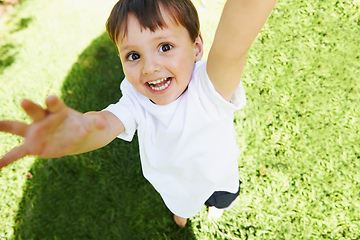 Image showing Yay Its time to play. High angle view of a little boy reaching up into the air.