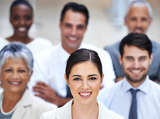 Image showing I lead by example. Portrait of a smiling businesswoman surrounded by a group of her colleagues.