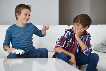 Image showing Haha, you lost again. Shot of a young boy laughing at his friend after beating him at a video game.