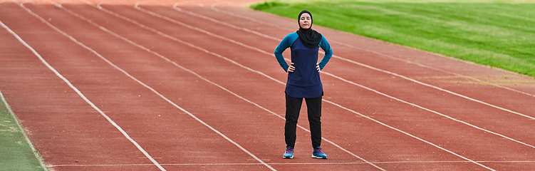 Image showing A muslim woman in a burqa sports muslim clothes running on a marathon course and preparing for upcoming competitions