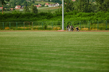 Image showing A cameraman filming the participants of the Paralympic race on the marathon course