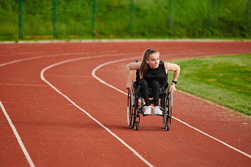 Image showing A woman with disablity driving a wheelchair on a track while preparing for the Paralympic Games