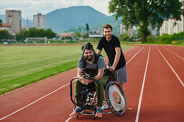 Image showing A cameraman filming the participants of the Paralympic race on the marathon course