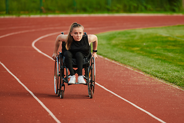 Image showing A woman with disablity driving a wheelchair on a track while preparing for the Paralympic Games