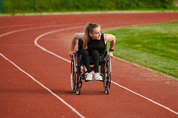 Image showing A woman with disablity driving a wheelchair on a track while preparing for the Paralympic Games