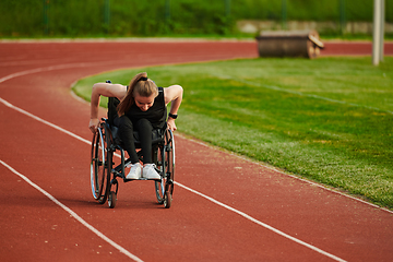 Image showing A woman with disablity driving a wheelchair on a track while preparing for the Paralympic Games