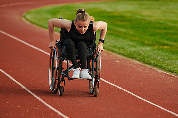 Image showing A woman with disablity driving a wheelchair on a track while preparing for the Paralympic Games