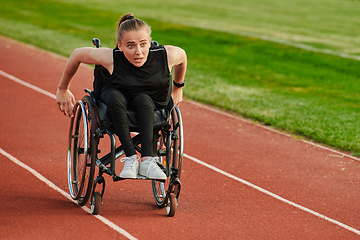 Image showing A woman with disablity driving a wheelchair on a track while preparing for the Paralympic Games