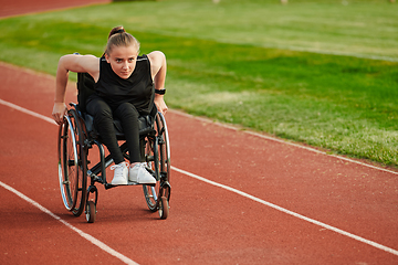 Image showing A woman with disablity driving a wheelchair on a track while preparing for the Paralympic Games