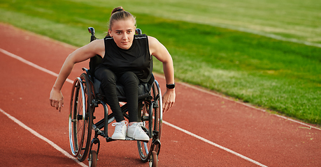 Image showing A woman with disablity driving a wheelchair on a track while preparing for the Paralympic Games