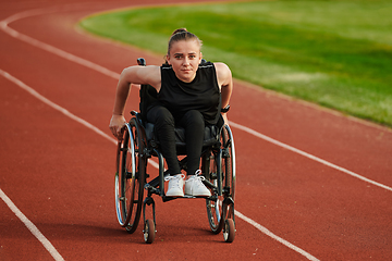 Image showing A woman with disablity driving a wheelchair on a track while preparing for the Paralympic Games