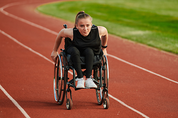 Image showing A woman with disablity driving a wheelchair on a track while preparing for the Paralympic Games