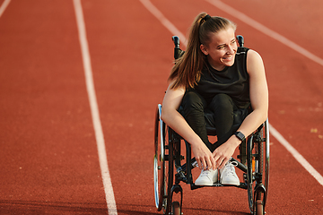 Image showing A woman with disablity driving a wheelchair on a track while preparing for the Paralympic Games