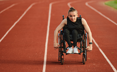 Image showing A woman with disablity driving a wheelchair on a track while preparing for the Paralympic Games