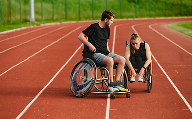 Image showing An inspiring couple with disability showcase their incredible determination and strength as they train together for the Paralympics pushing their wheelchairs in marathon track