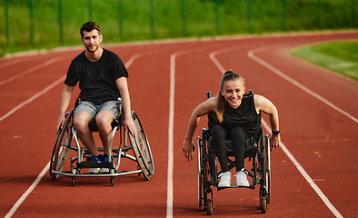 Image showing An inspiring couple with disability showcase their incredible determination and strength as they train together for the Paralympics pushing their wheelchairs in marathon track