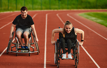 Image showing An inspiring couple with disability showcase their incredible determination and strength as they train together for the Paralympics pushing their wheelchairs in marathon track