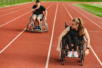 Image showing An inspiring couple with disability showcase their incredible determination and strength as they train together for the Paralympics pushing their wheelchairs in marathon track