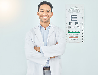 Image showing Ophthalmologist, portrait and man with arms crossed in hospital mockup space for healthcare of vision. Face, confident optometrist and happy doctor, Asian optician or medical professional in Cambodia