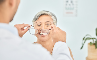 Image showing Smile, glasses and hands of ophthalmologist on woman in hospital for vision, healthcare or wellness. Frame, optometrist and mature patient happy for eyewear, lens or prescription spectacles in clinic