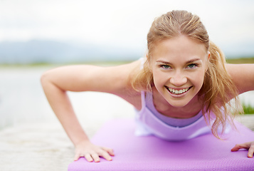 Image showing Push yourself. Shot of a young woman doing yoga outdoors.