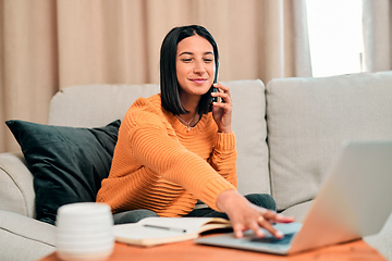 Image showing Lifes short, spend it productively. Shot of a young woman using a laptop and smartphone while working on the sofa at home.