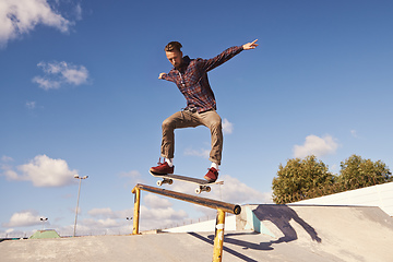 Image showing Like flying. Shot of a skateboarder performing a trick on a rail.