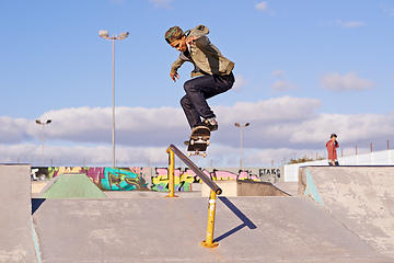 Image showing Grinding like a pro. Shot of a skateboarder performing a trick on a rail.