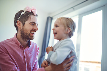 Image showing His daughter fills his world with joy and laughter. Shot of a young man spending quality time with his adorable daughter at home.