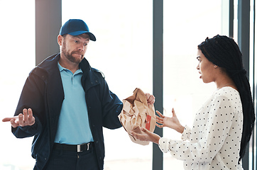 Image showing Im sorry but theres nothing I can do about this. Shot of a handsome delivery man negotiating with a dissatisfied female customer in the lobby.