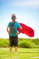 Image showing No dirt or mud will slow me down. Portrait of a muddy little boy dressed up like a superhero.