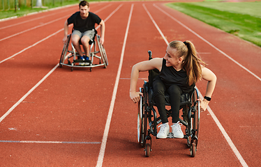 Image showing An inspiring couple with disability showcase their incredible determination and strength as they train together for the Paralympics pushing their wheelchairs in marathon track