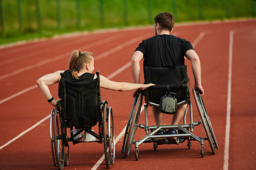 Image showing An inspiring couple with disability showcase their incredible determination and strength as they train together for the Paralympics pushing their wheelchairs in marathon track