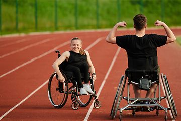 Image showing An inspiring couple with disability showcase their incredible determination and strength as they train together for the Paralympics pushing their wheelchairs in marathon track