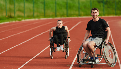 Image showing An inspiring couple with disability showcase their incredible determination and strength as they train together for the Paralympics pushing their wheelchairs in marathon track