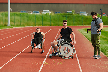 Image showing A cameraman filming the participants of the Paralympic race on the marathon course