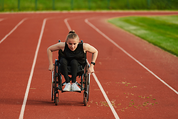 Image showing A woman with disablity driving a wheelchair on a track while preparing for the Paralympic Games