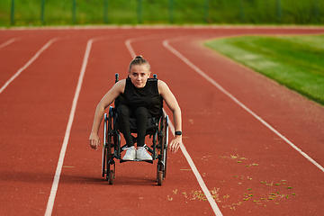 Image showing A woman with disablity driving a wheelchair on a track while preparing for the Paralympic Games