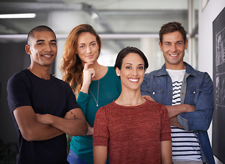 Image showing Positive about work. Cropped portrait of a team of young creative professionals standing in the office.