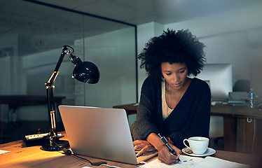 Image showing Powering through to knockout her deadlines. Cropped shot of a young businesswoman working late on a laptop in an office.