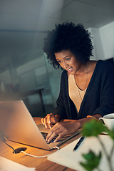 Image showing Just editing the last few details before heading home. Cropped shot of a young businesswoman working late on a laptop in an office.