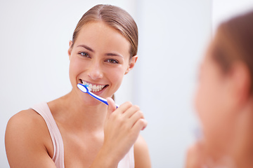 Image showing Taking care of her smile. A young woman brushing her teeth.