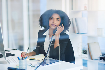 Image showing On call with some important clients. Shot of a young businesswoman talking on a telephone in an office.